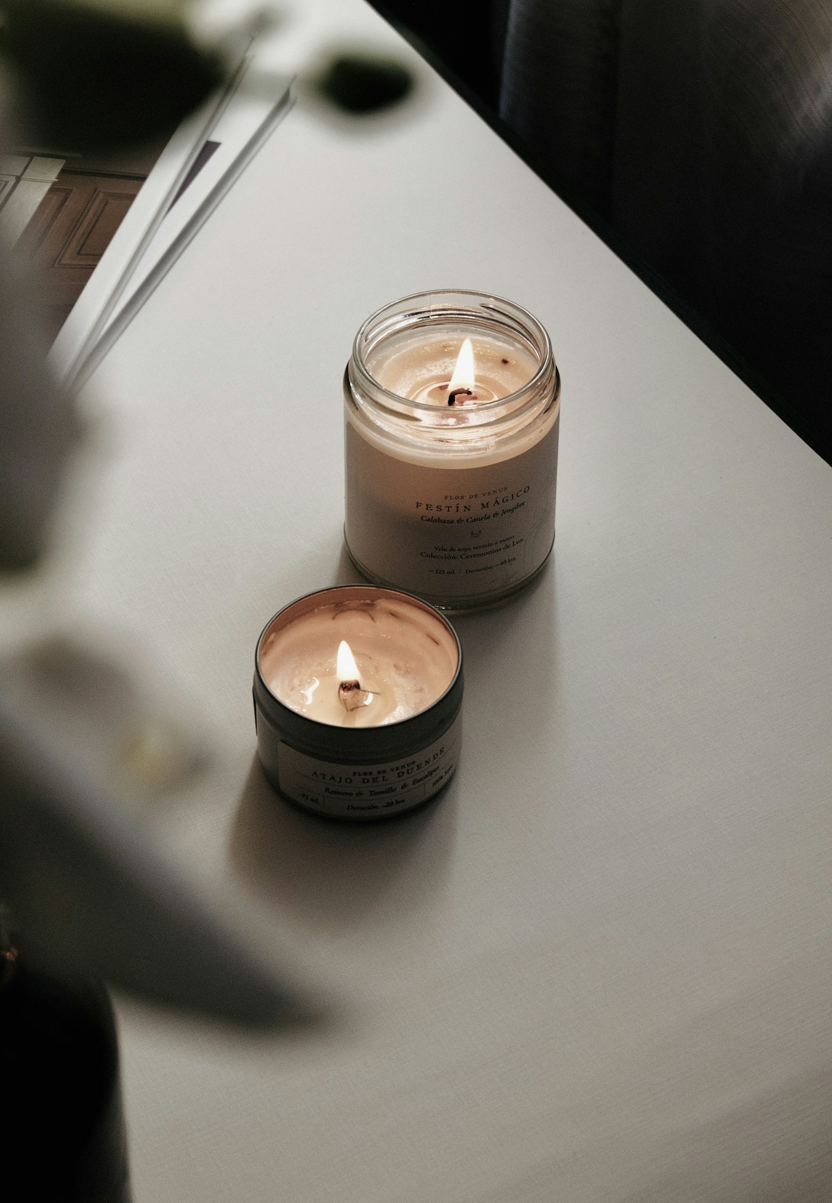 lit candle and diffuser on a calm shelf